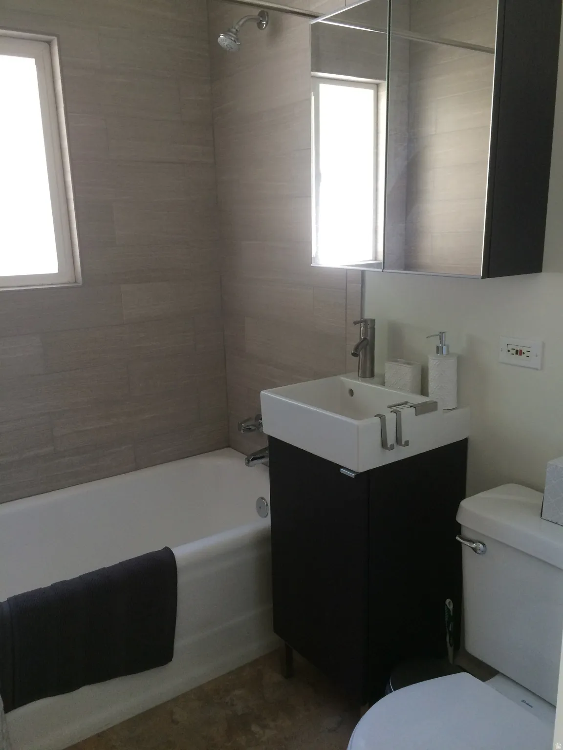 Bathroom featuring vanity and shower / tub combination