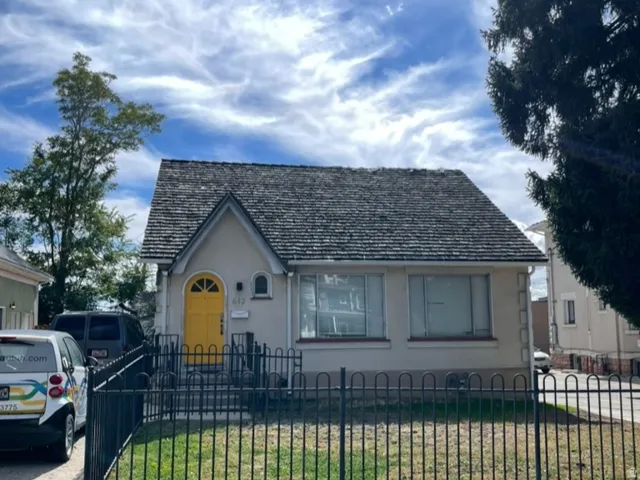 View of front facade with a fenced front yard and stucco siding
