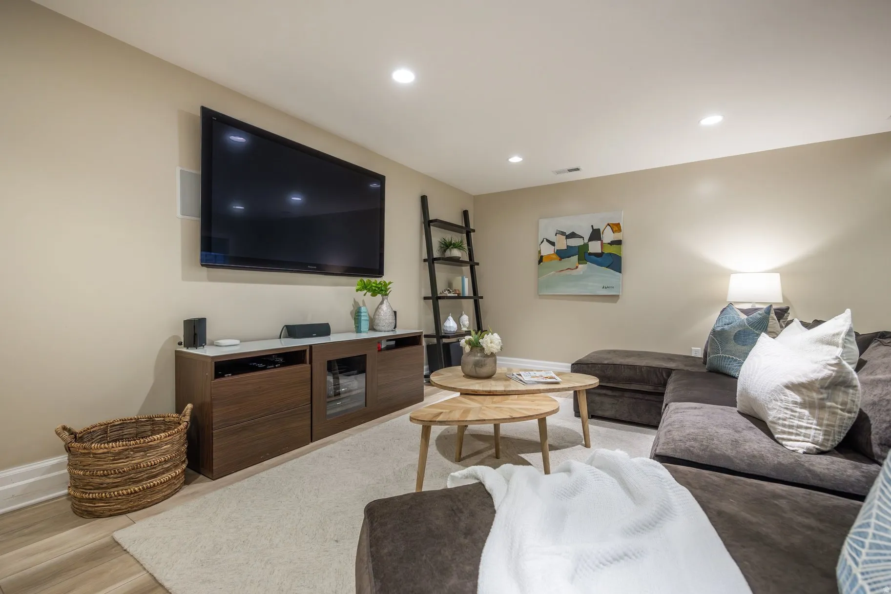 Living room with recessed lighting and light wood-style floors