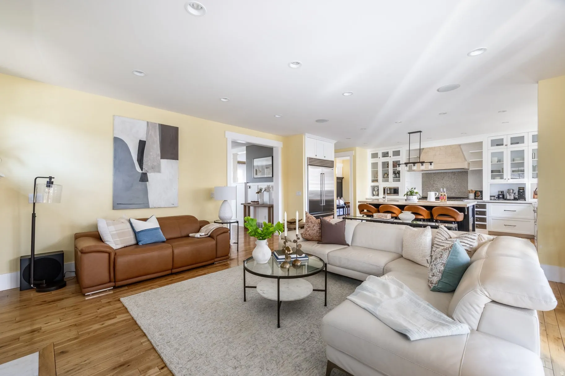 Living room with light wood-style flooring and recessed lighting