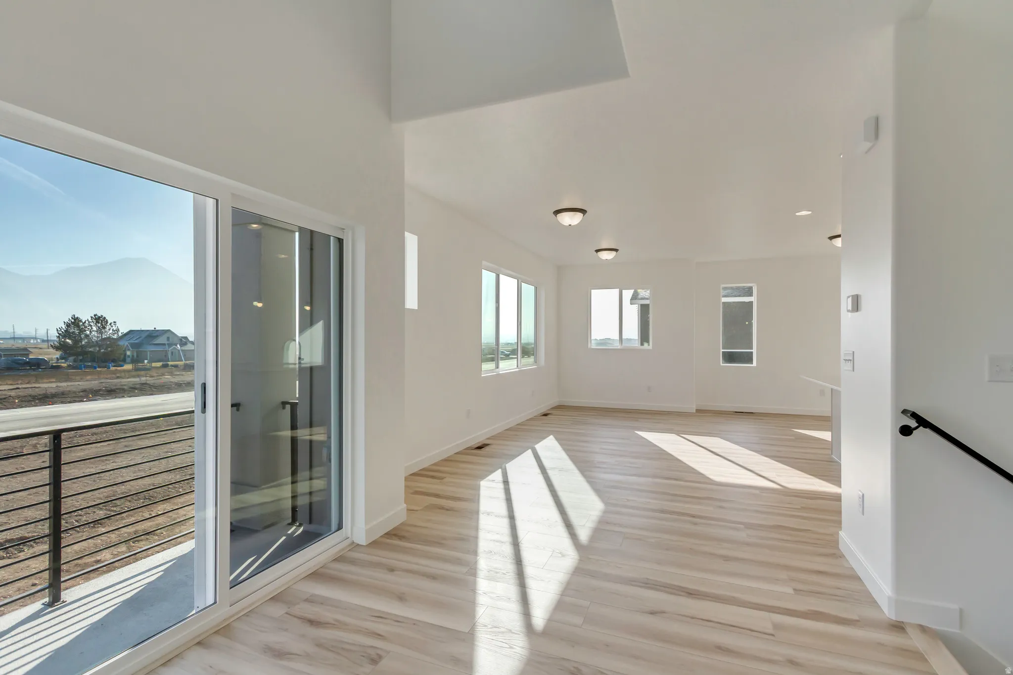 Empty room with light wood-style flooring and baseboards