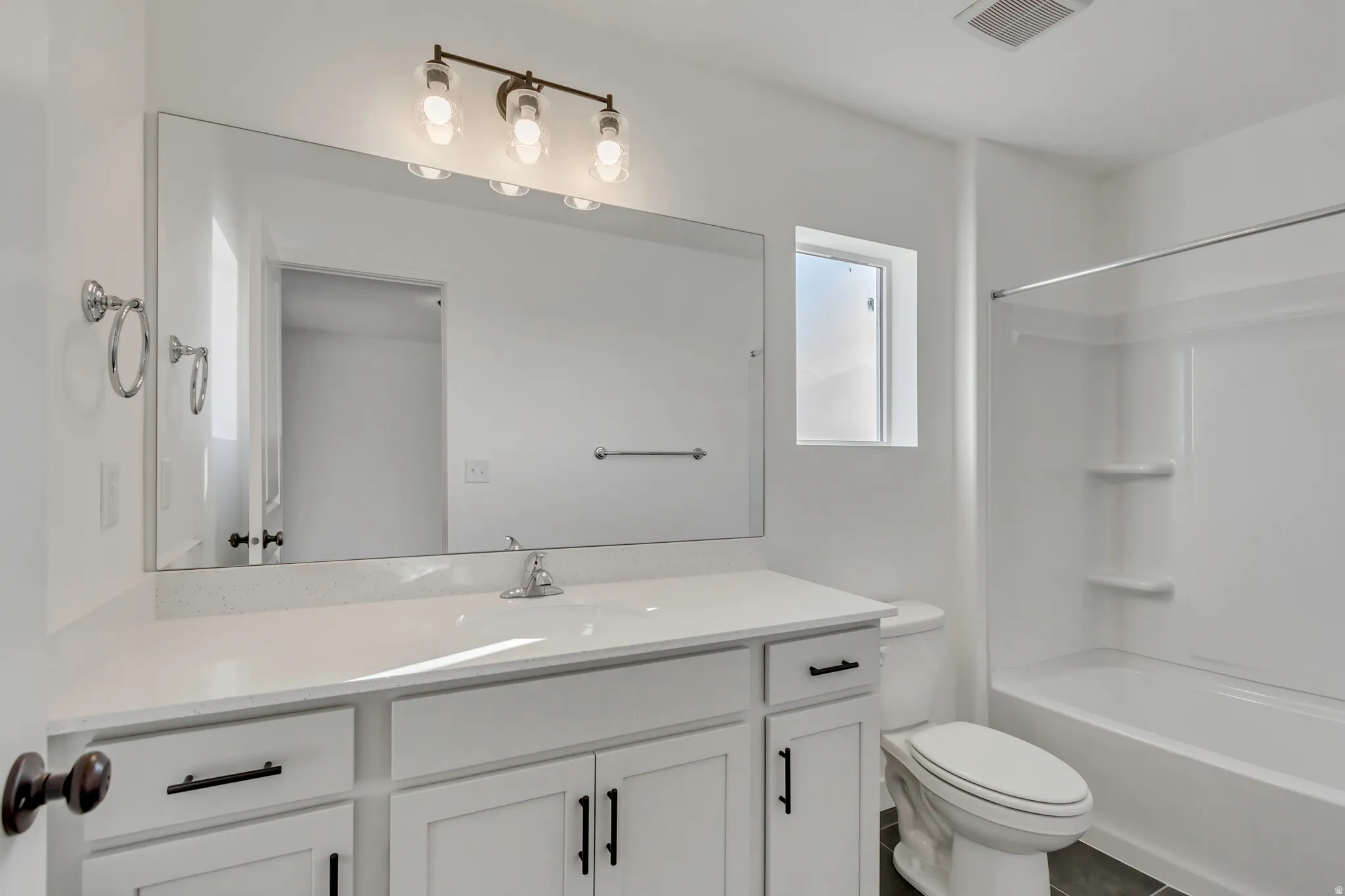 Bathroom featuring vanity and bathing tub / shower combination
