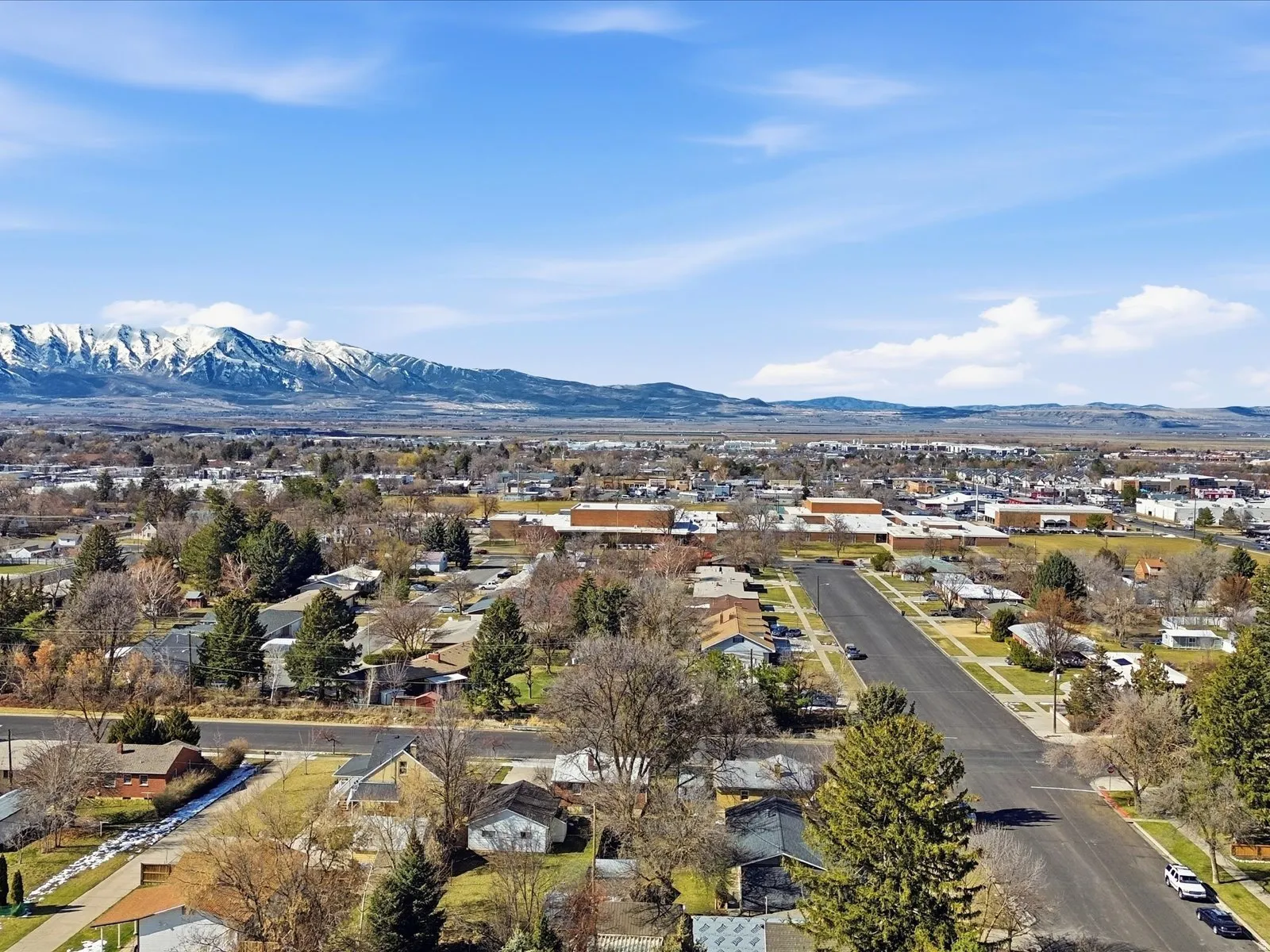 Aerial view of residential area featuring a mountain backdrop