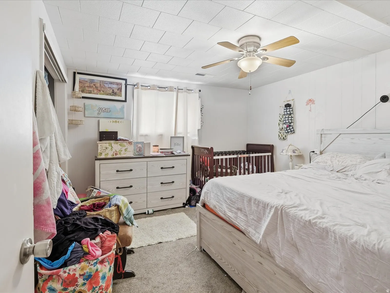 Bedroom featuring light carpet and a ceiling fan