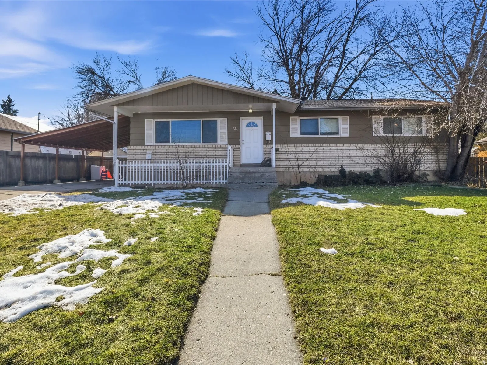 View of front of home with a carport and brick siding