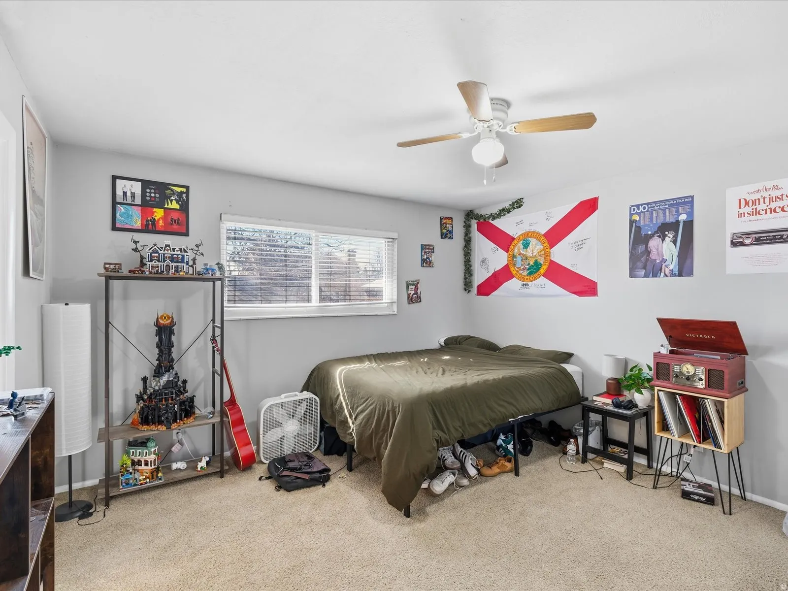 Bedroom featuring light colored carpet and a ceiling fan