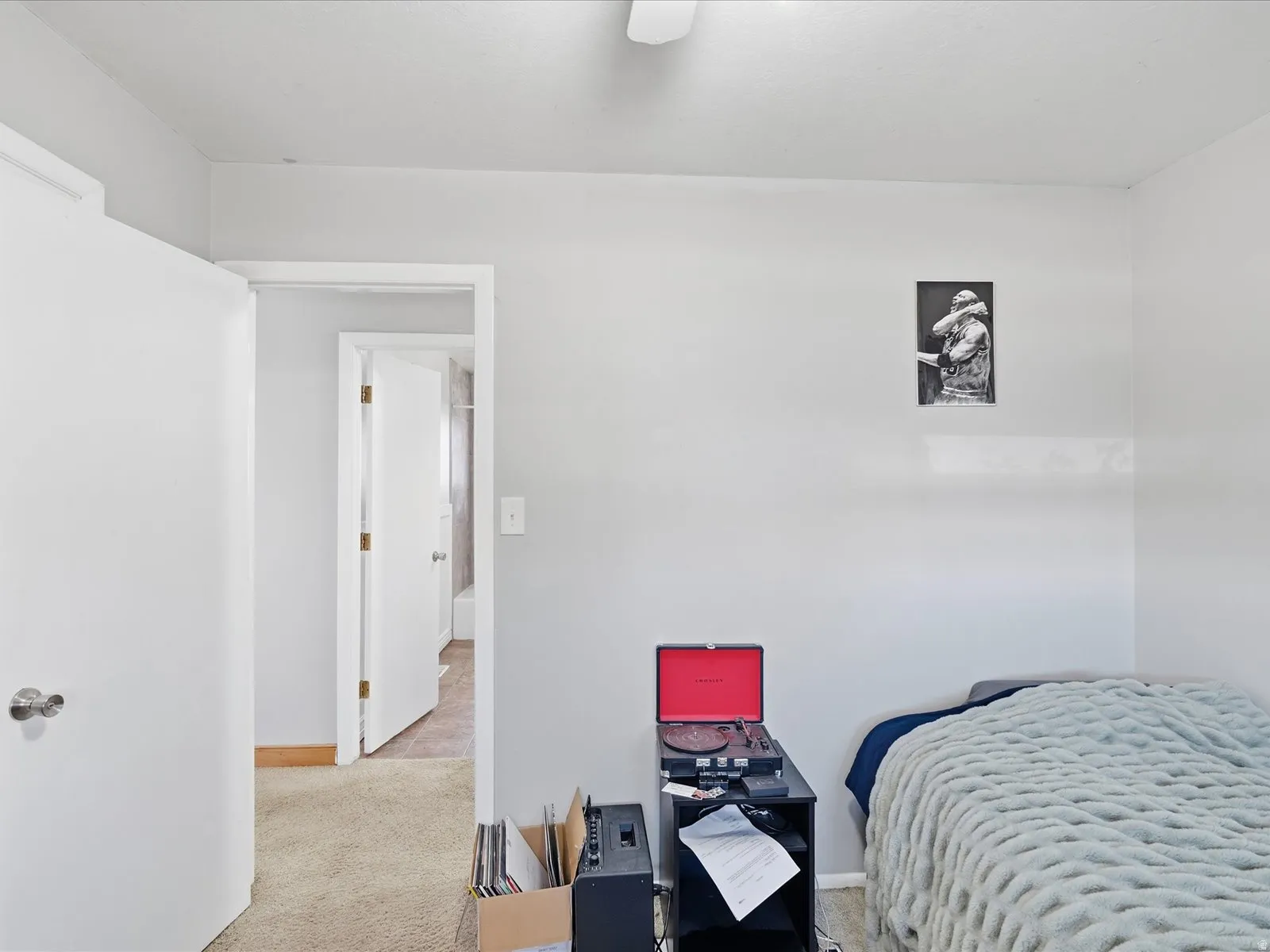 Bedroom featuring a desk, light carpet, and ceiling fan