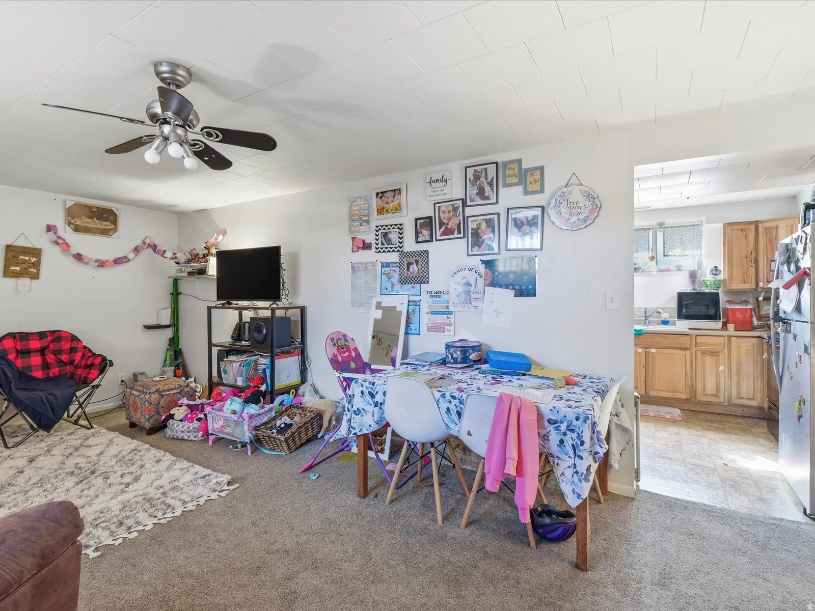 Dining room featuring light carpet and a ceiling fan