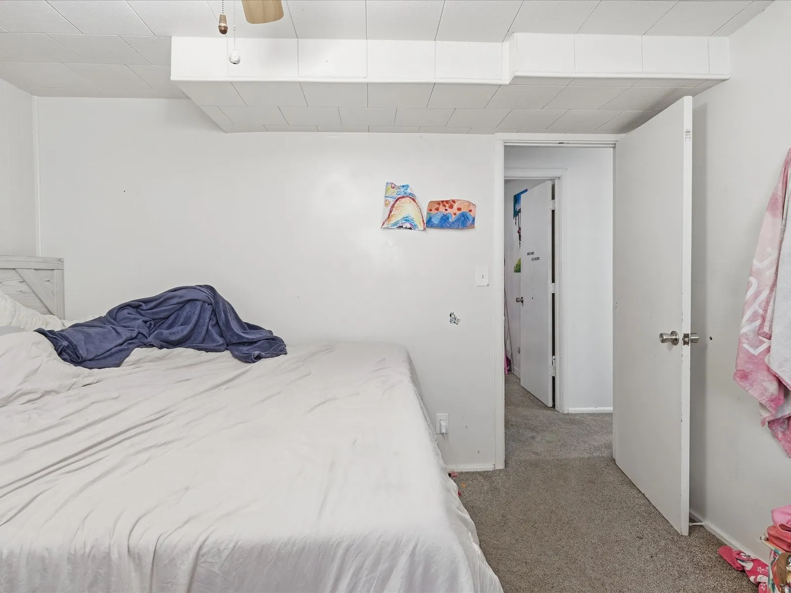 Carpeted bedroom with baseboards and a ceiling fan