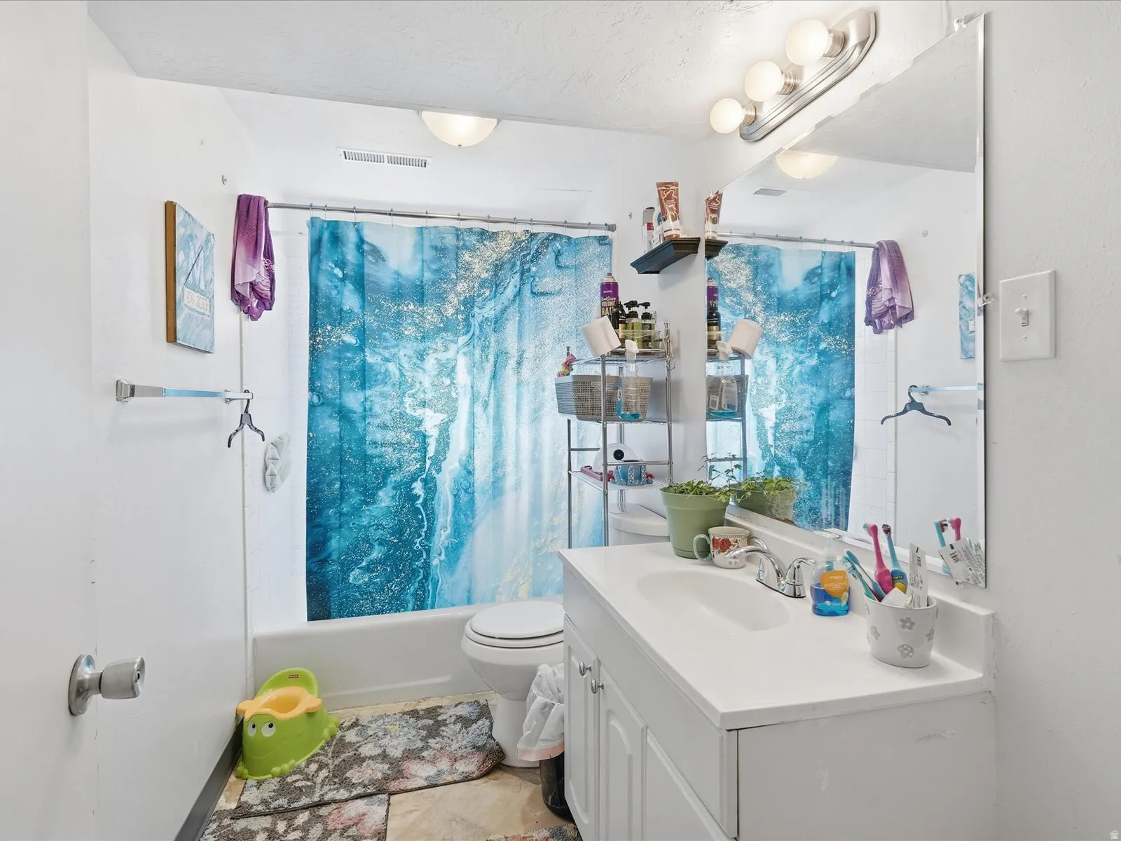Full bath featuring vanity and shower / bath combo