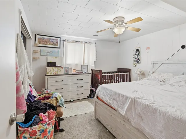Bedroom featuring light carpet and a ceiling fan