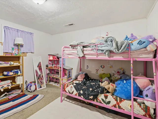 Bedroom with a textured ceiling