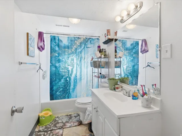 Full bath featuring vanity and shower / bath combo