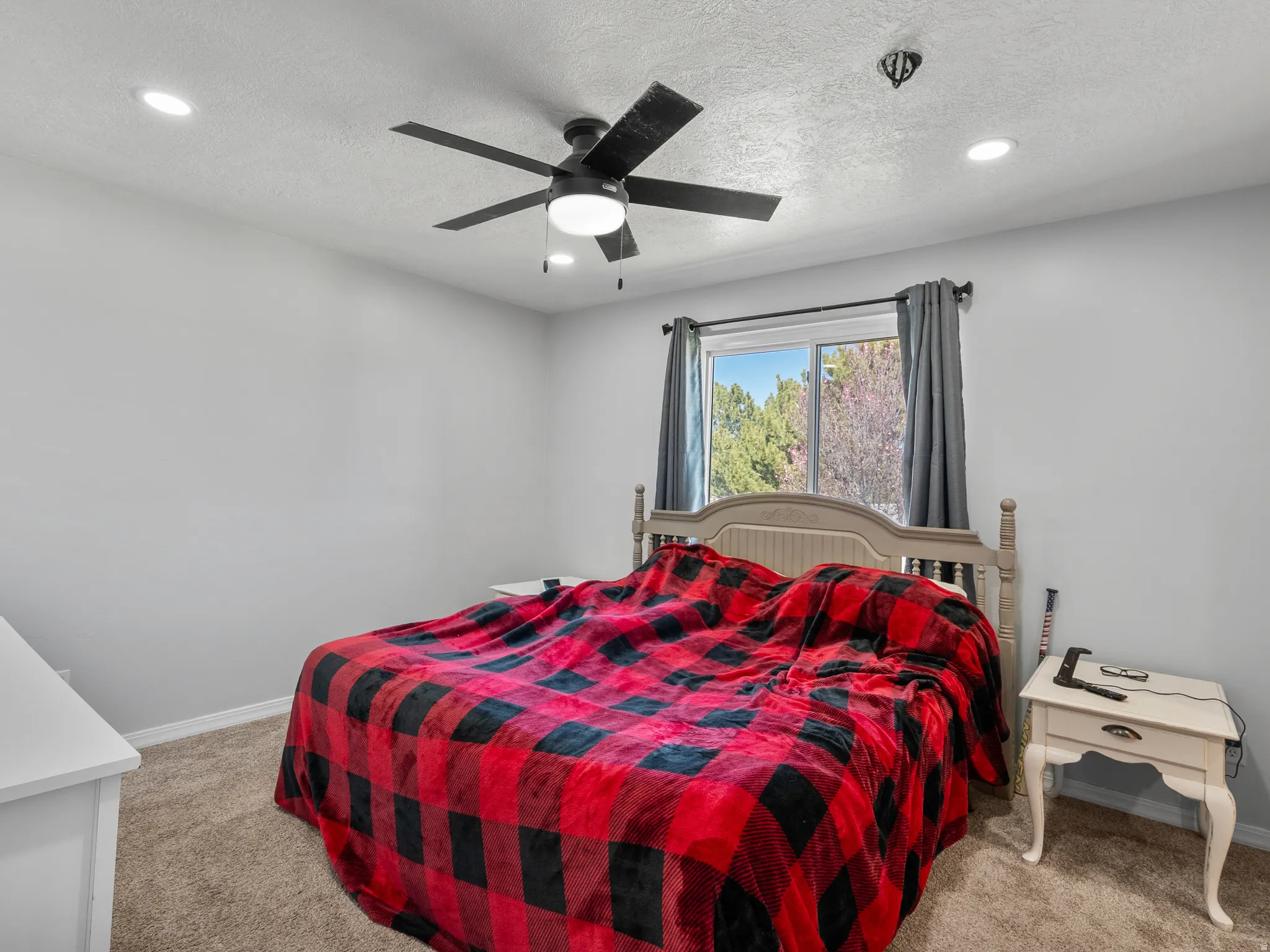Bedroom featuring light colored carpet, ceiling fan, recessed lighting, and a textured ceiling