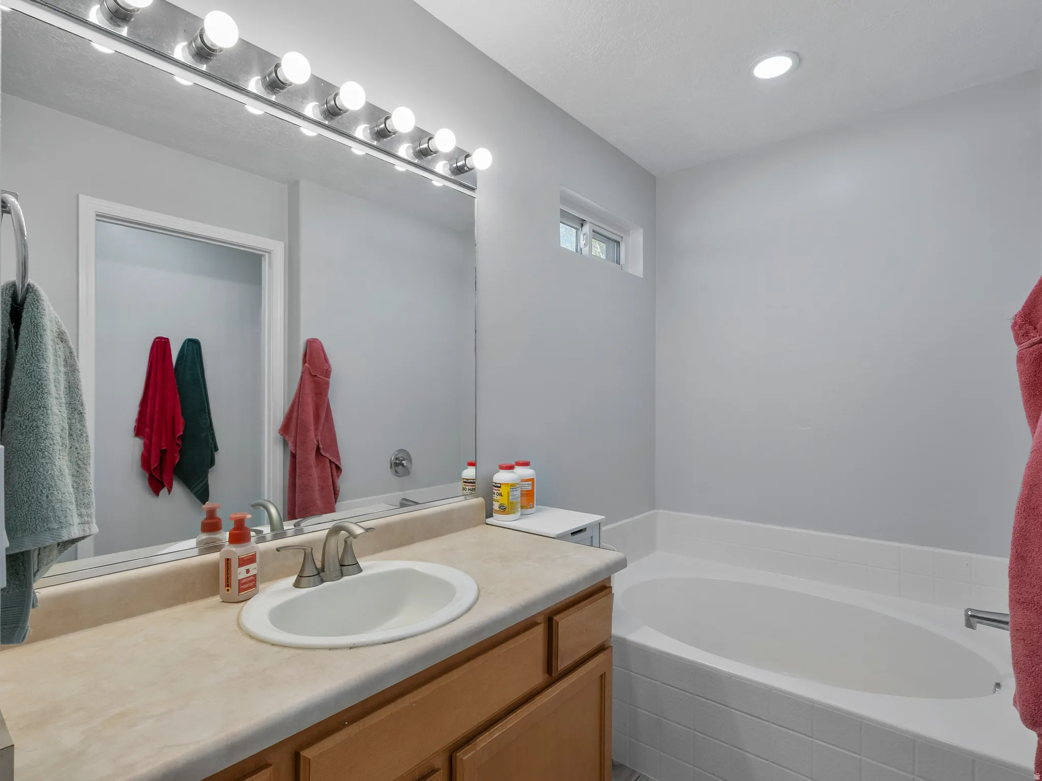 Full bathroom featuring vanity and a bath