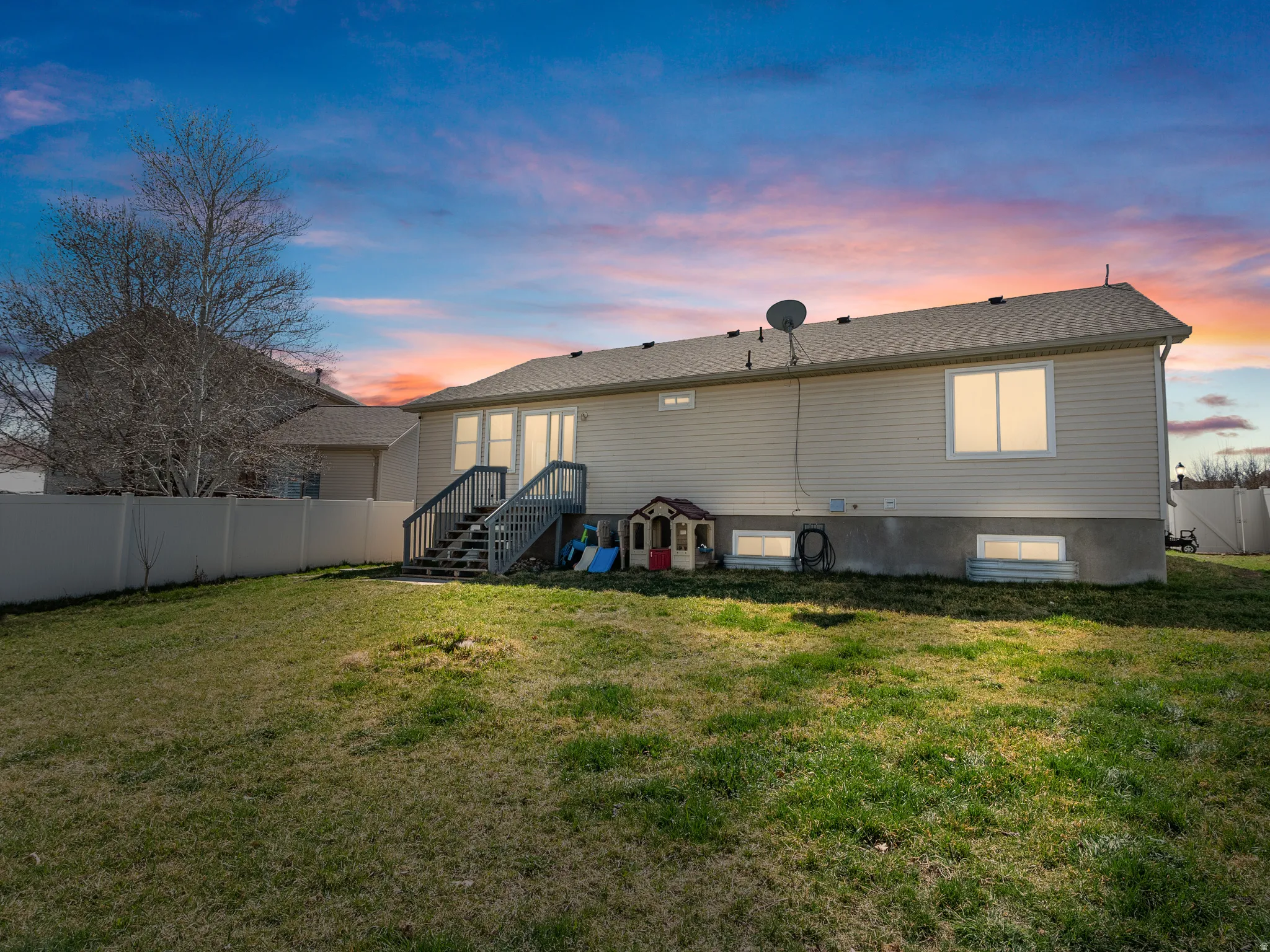 View of back of property at dusk