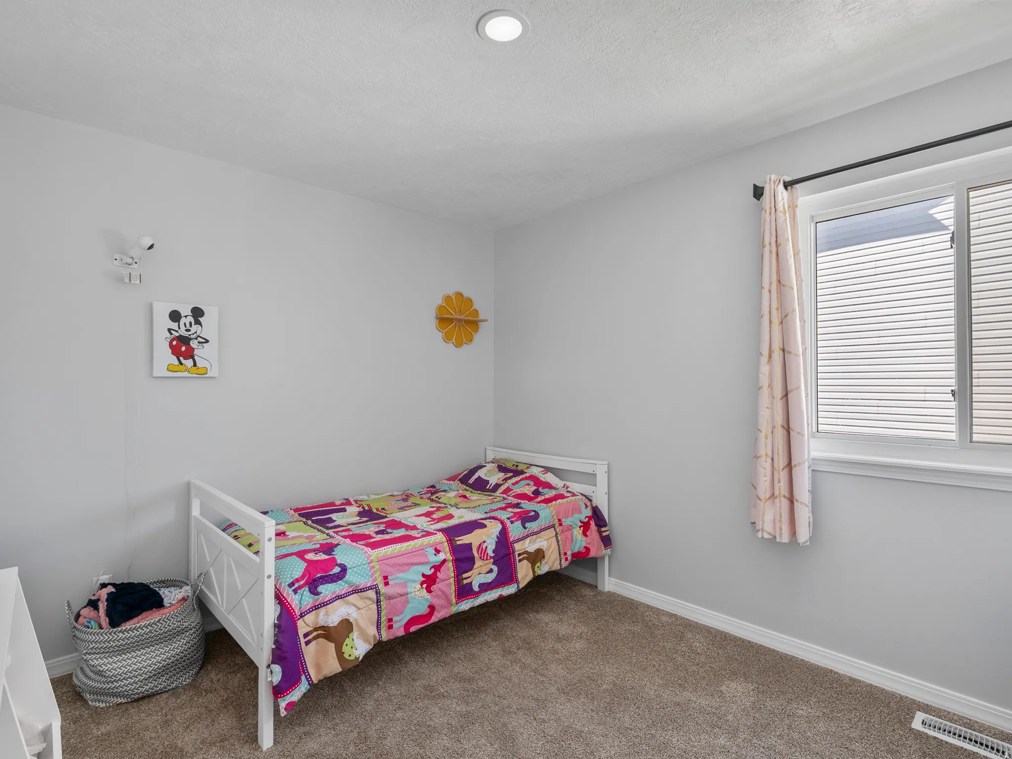 Bedroom featuring dark carpet and baseboards