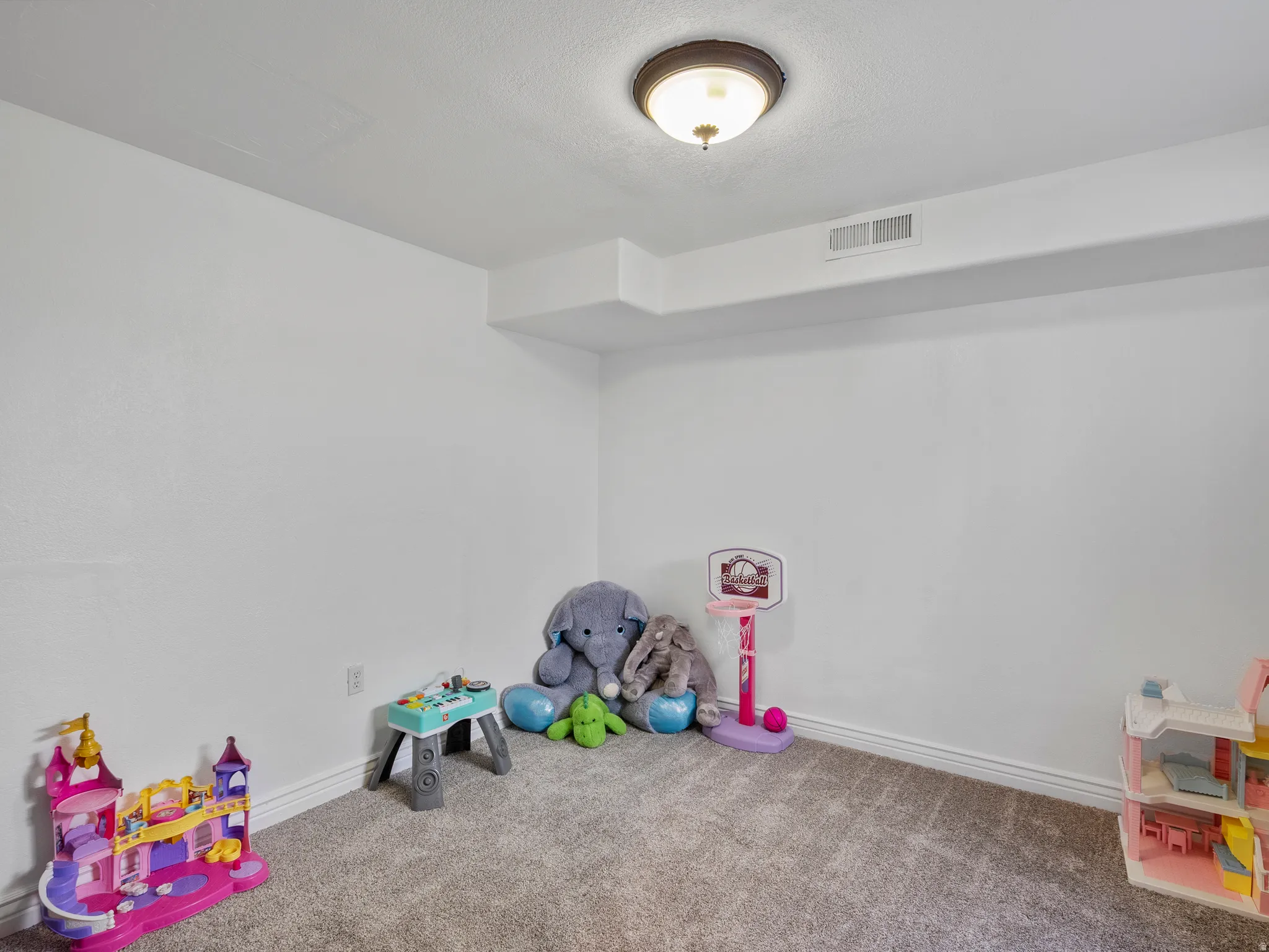 Playroom featuring carpet floors and baseboards