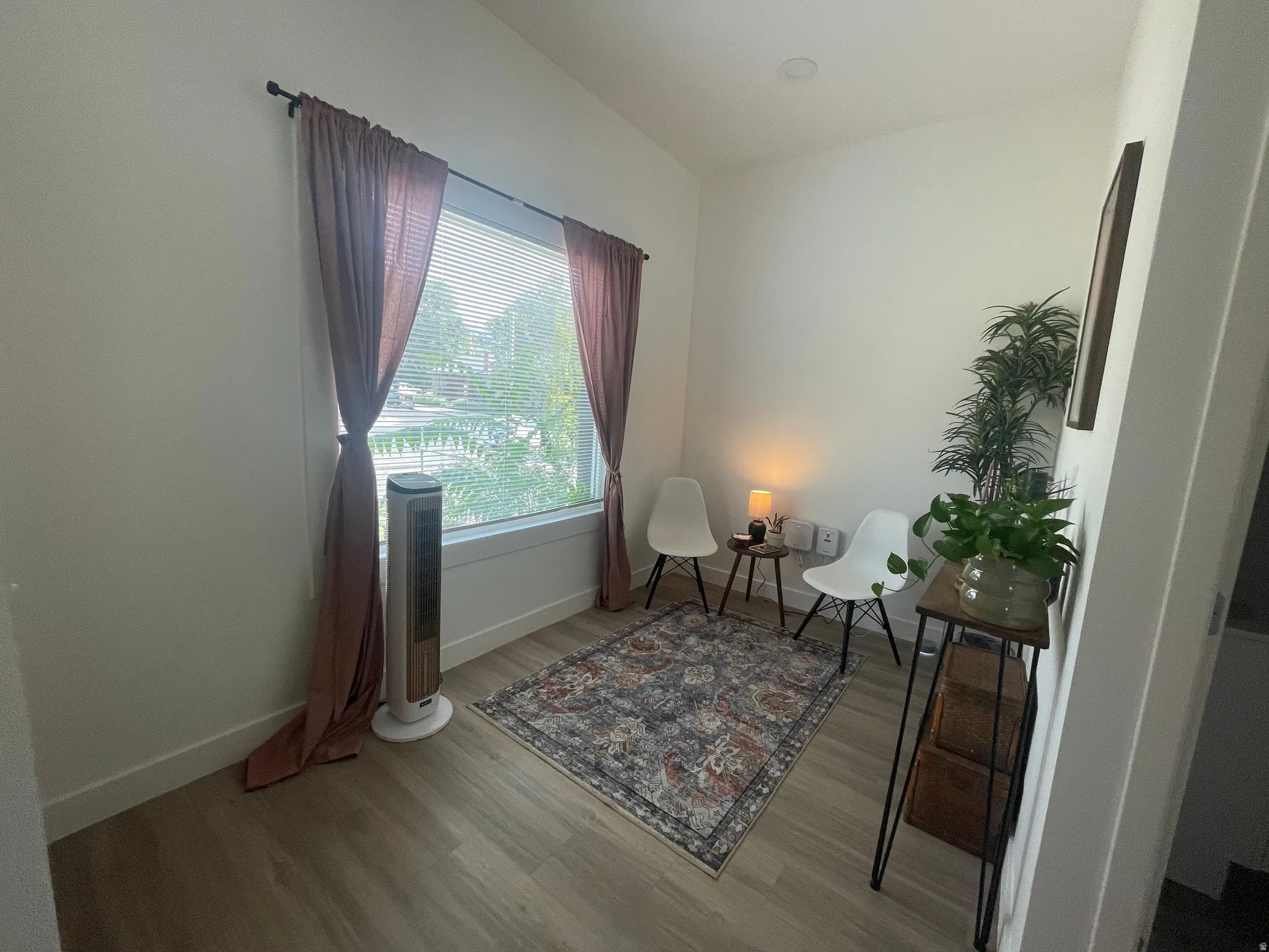 Sitting room featuring light wood-style floors and baseboards