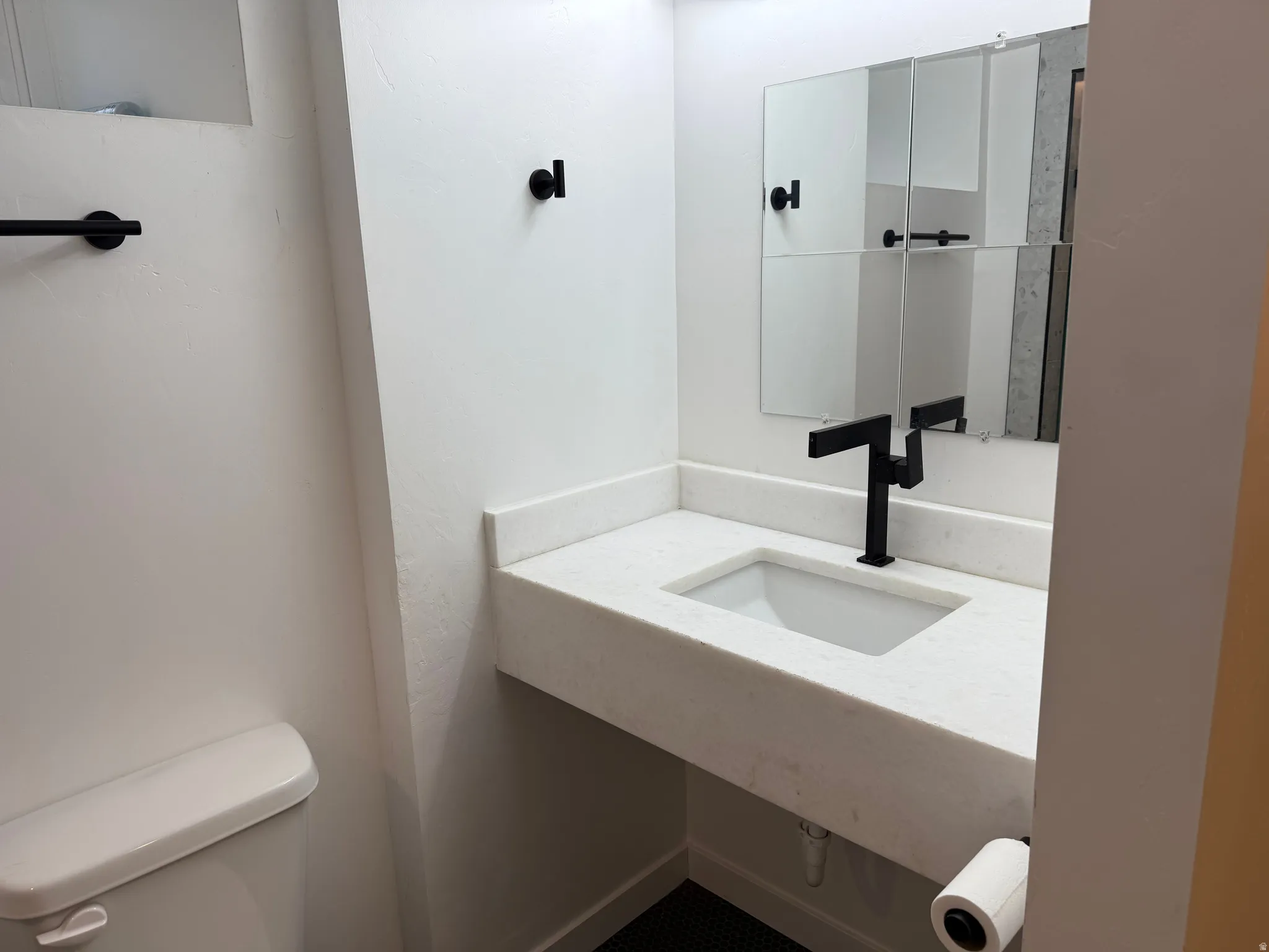 Half bath featuring toilet and vanity