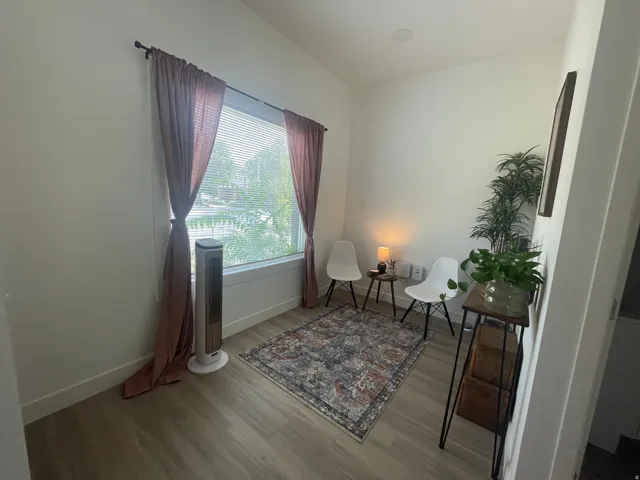 Sitting room featuring light wood-style floors and baseboards