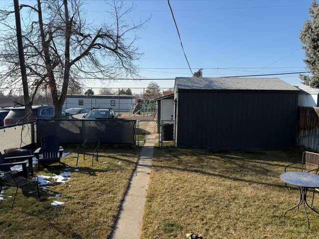 View of yard with a gate and an outbuilding