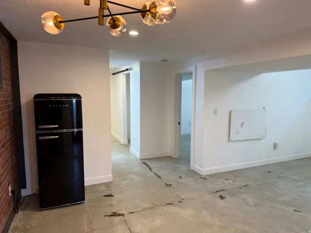 Unfurnished dining area with baseboards and a chandelier