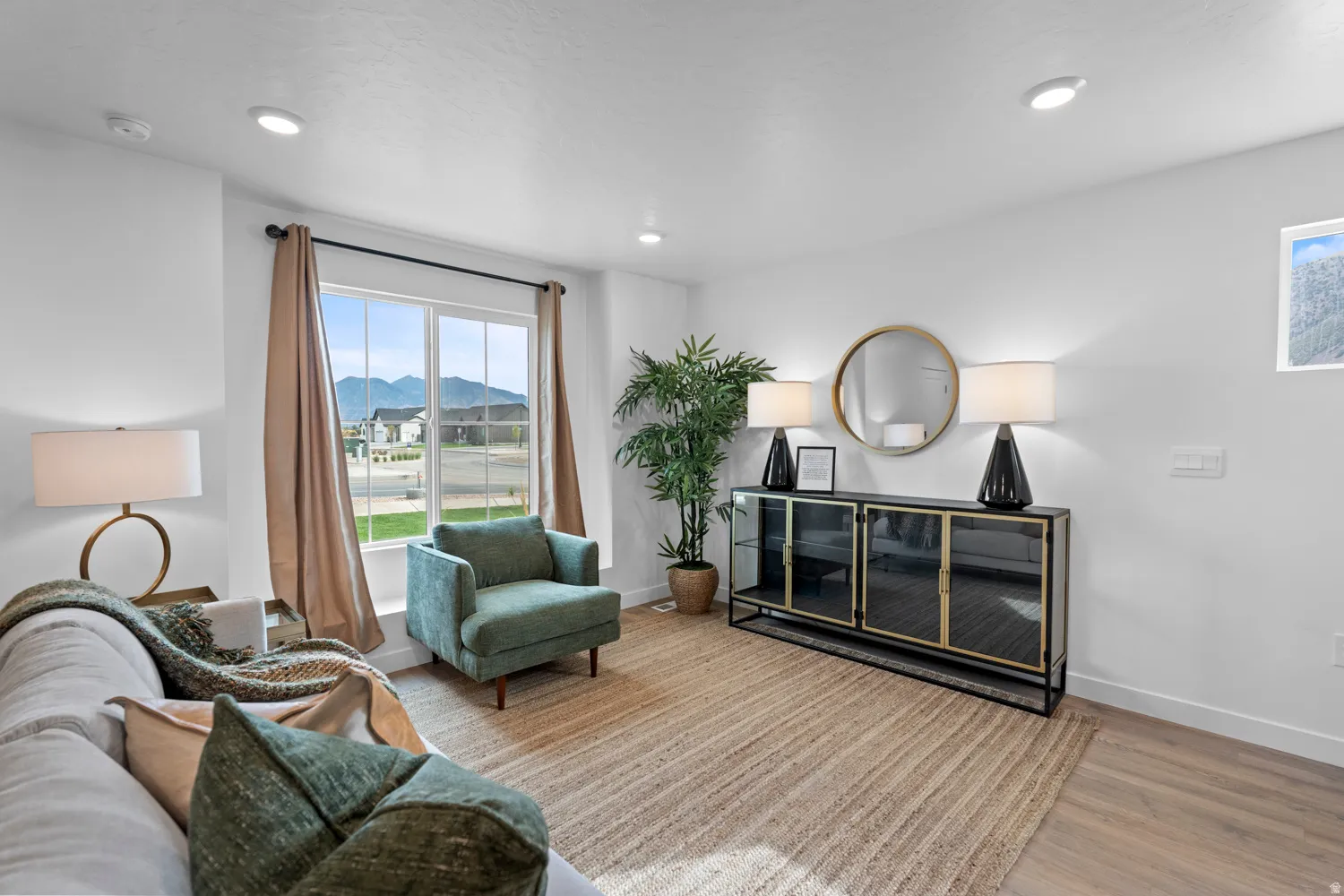 Sitting room with a mountain view, wood finished floors, and recessed lighting