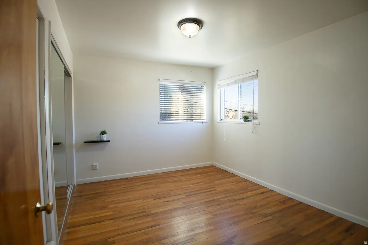Bedroom 1 with hardwood floors and lots of natural light