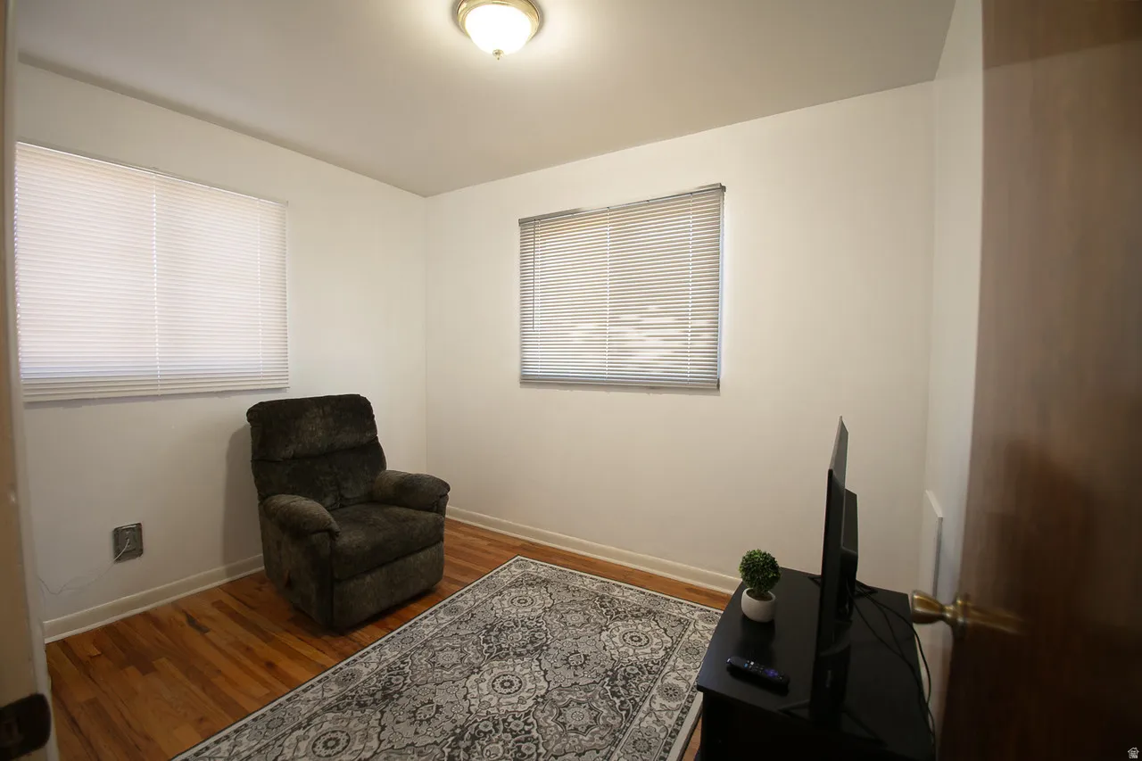 Bedroom 2 main level with hardwood floors, closet and natural light