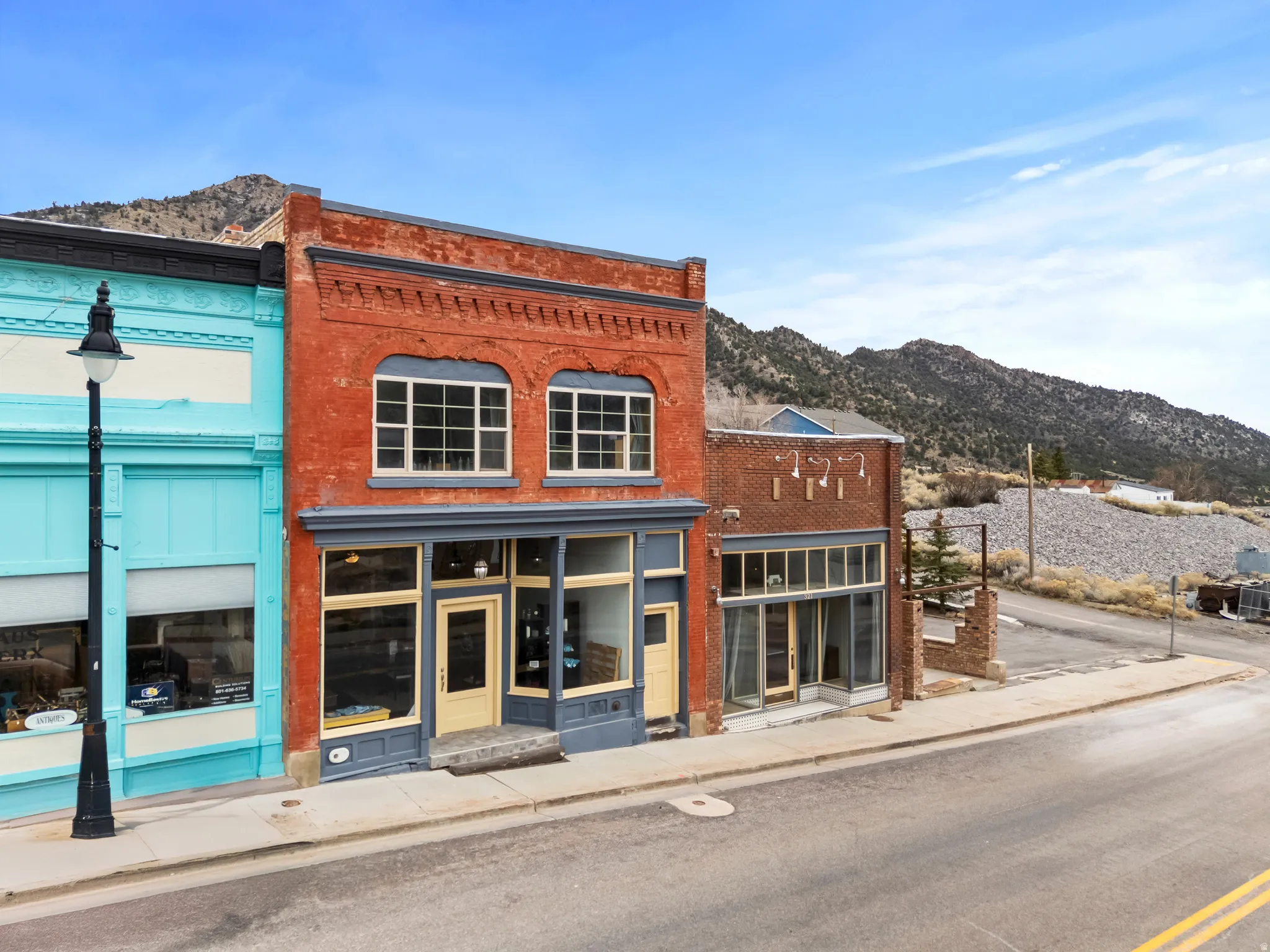 Store front entrance - north side of building. Facing Main Street. View of commercial property with a mountain view
