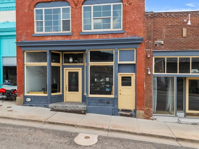 Store front entrance - north side of building. Facing Main Street. Doorway to property with brick siding