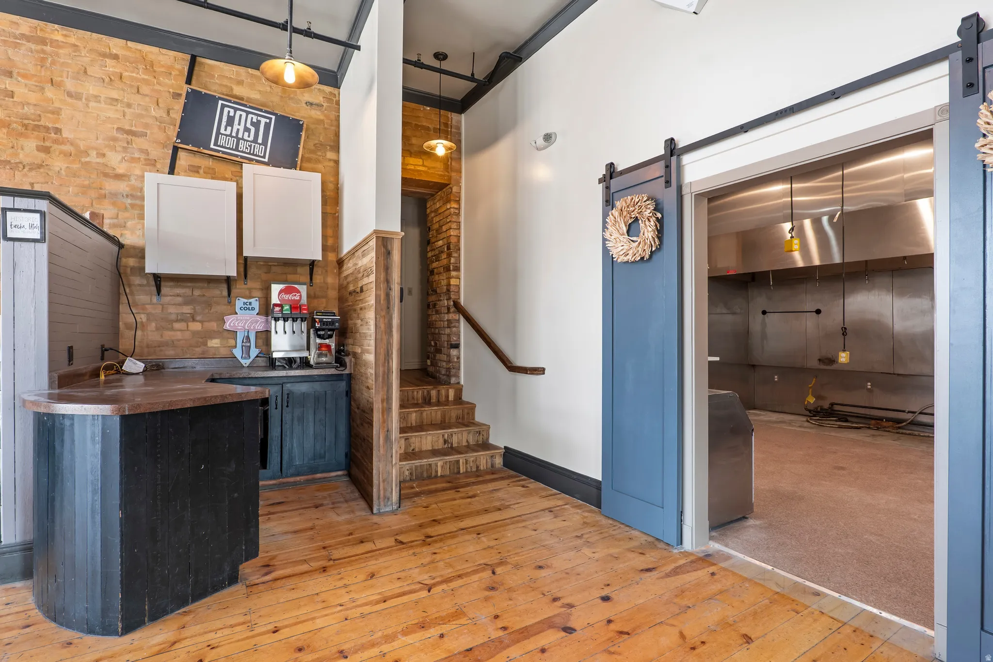 Bar with brick wall, a barn door, and wood counters