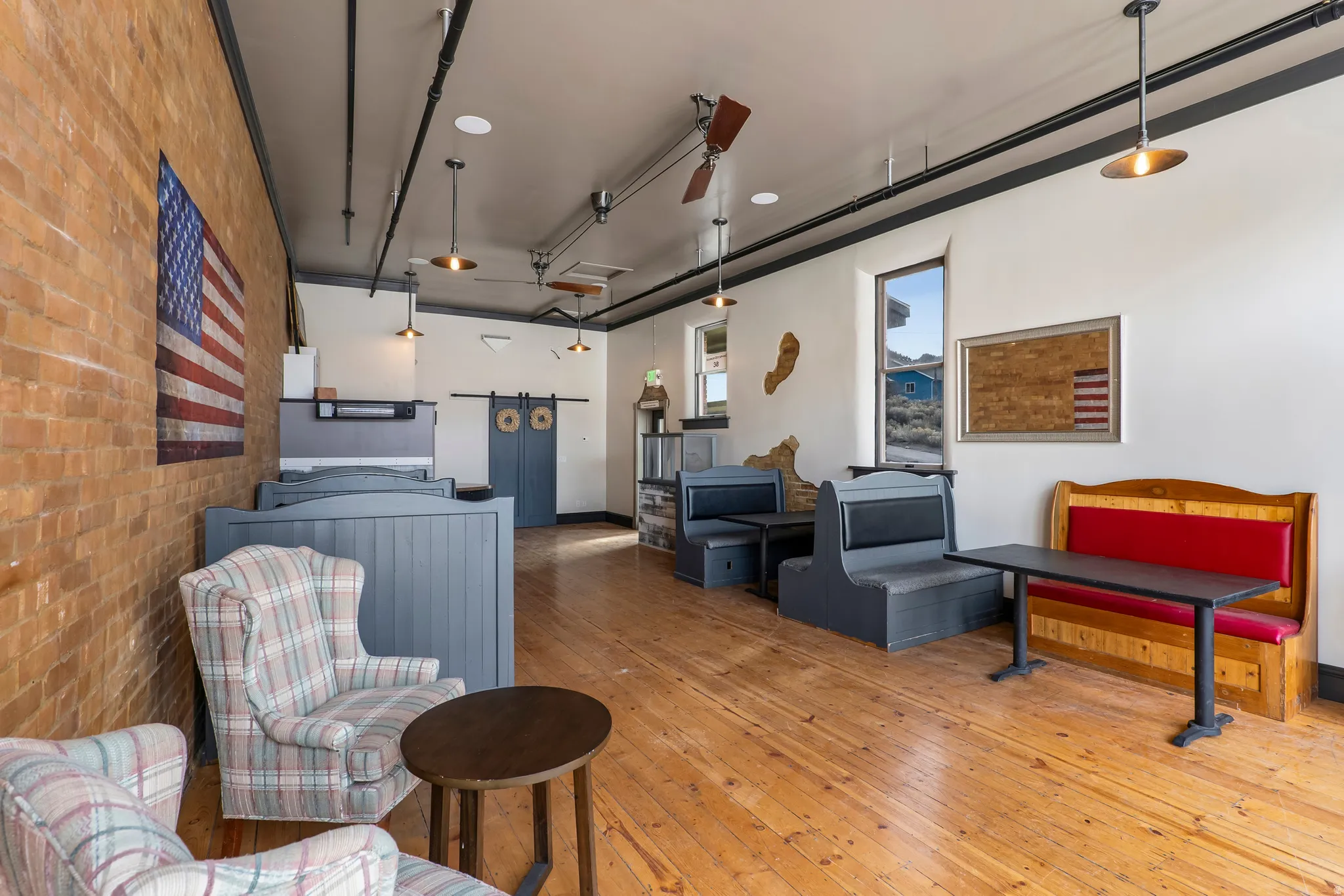 Living room with brick wall and light wood-type flooring