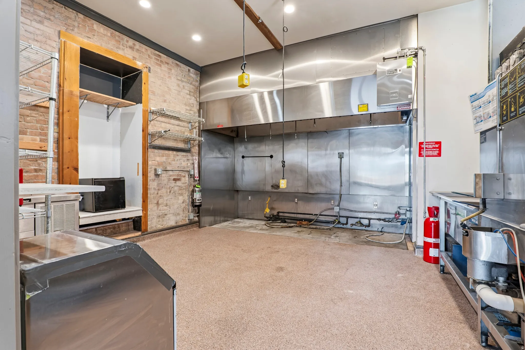 Kitchen featuring brick wall