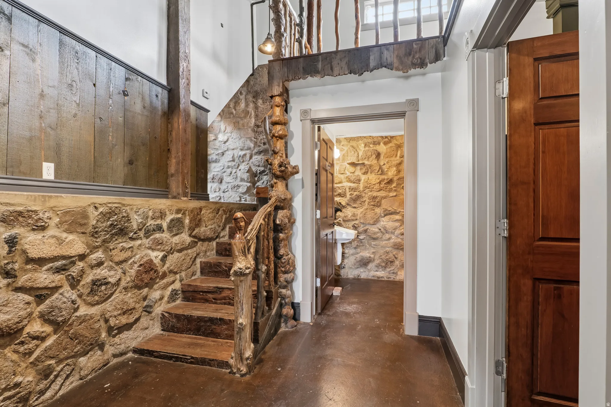 Stairway featuring concrete floors and baseboards