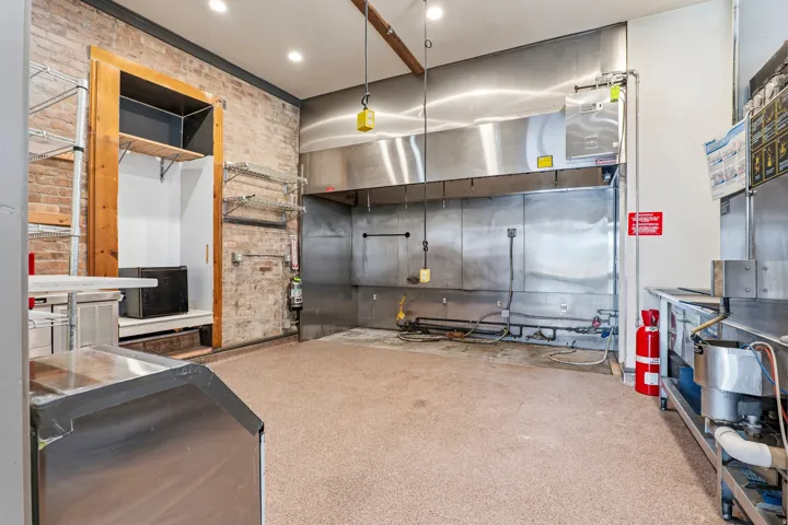 Kitchen featuring brick wall