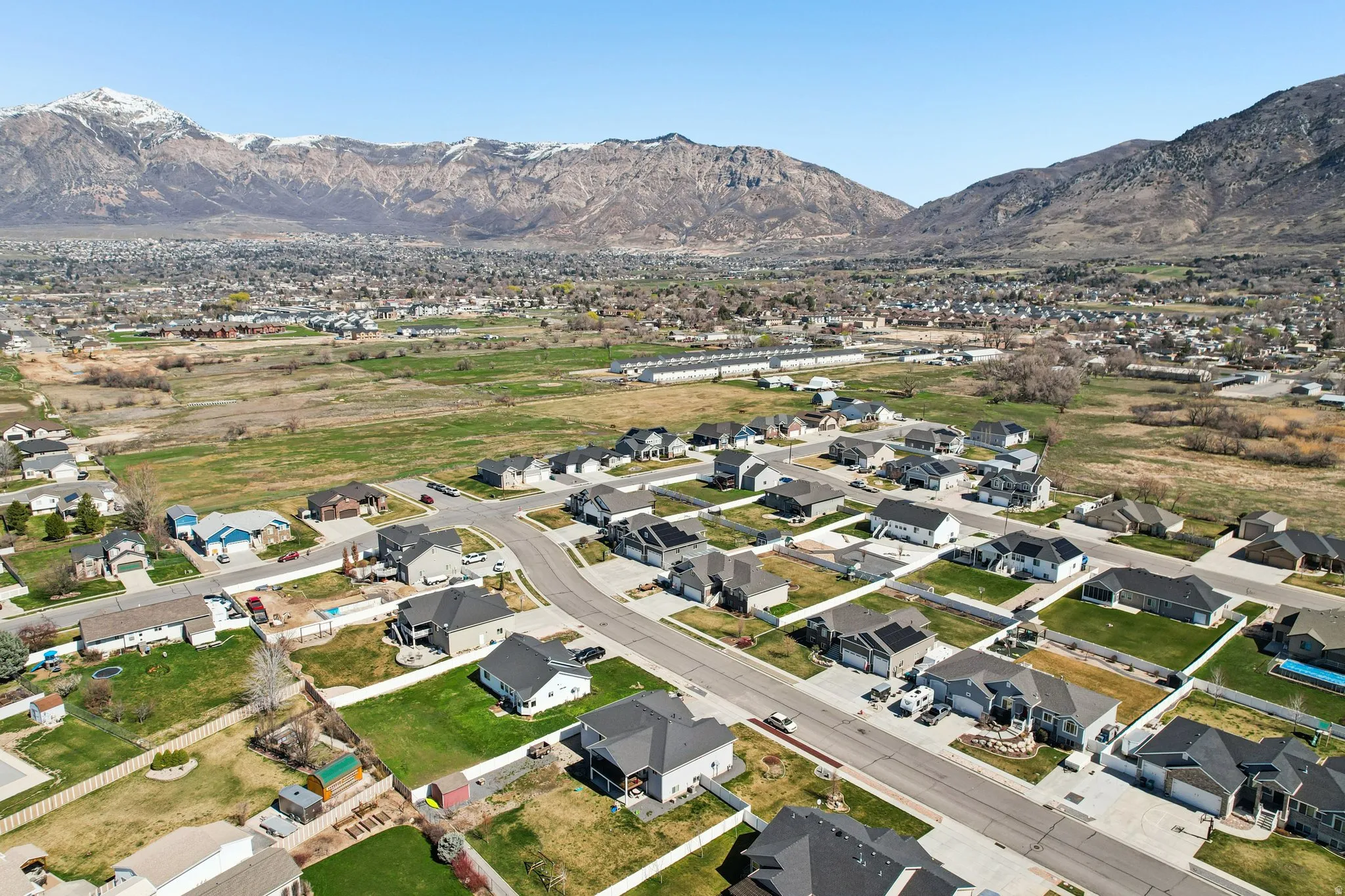 Aerial overview of property's location featuring nearby suburban area and a mountainous background