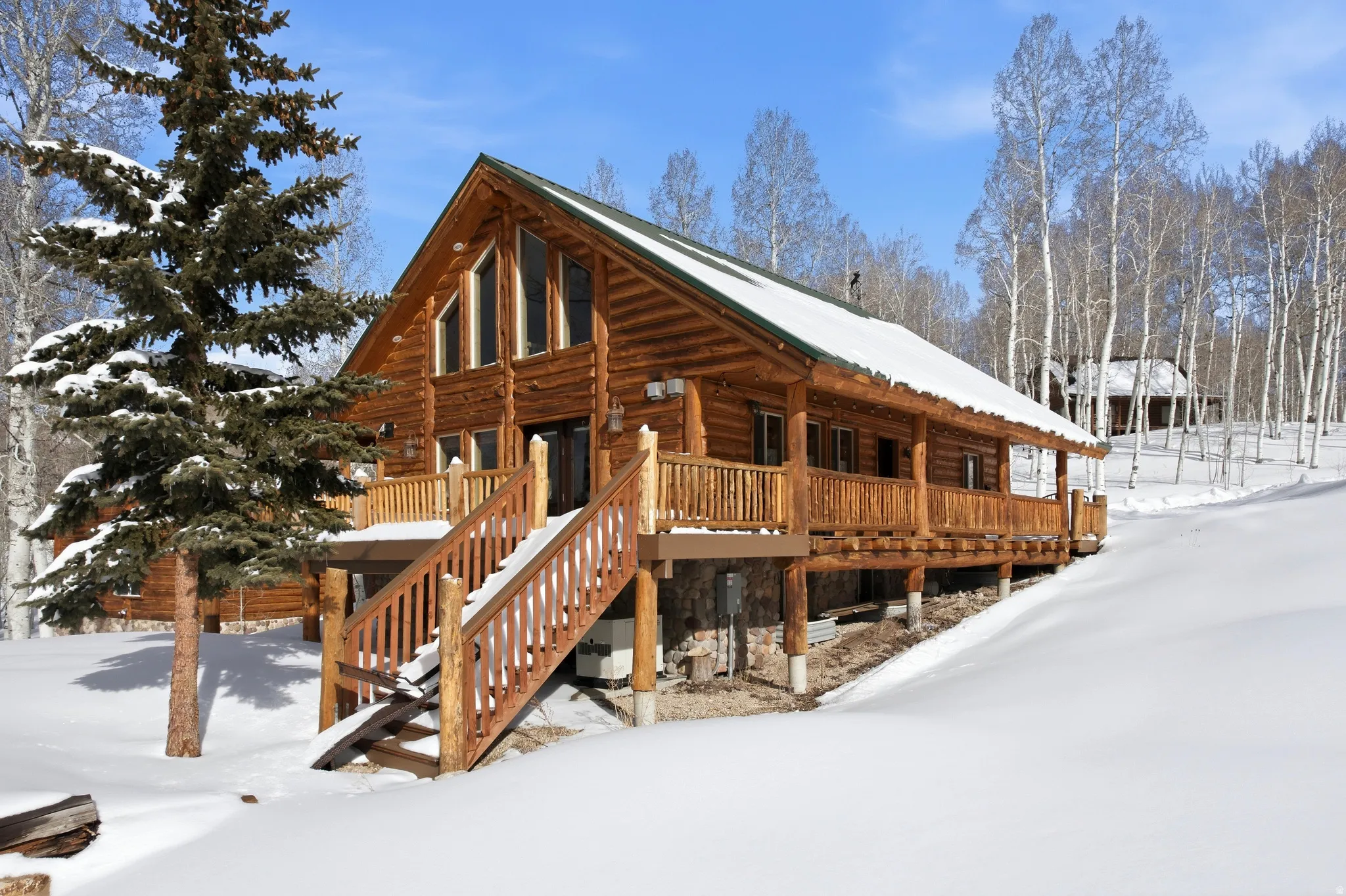 View of snow covered exterior with a porch and stairs