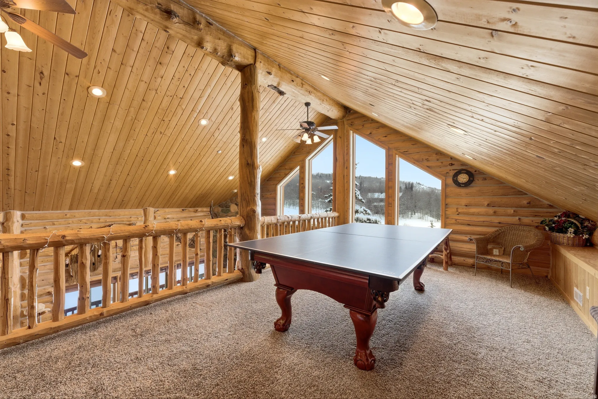Game room with log walls, a ceiling fan, carpet flooring, a wooden ceiling with exposed beams, and recessed lighting