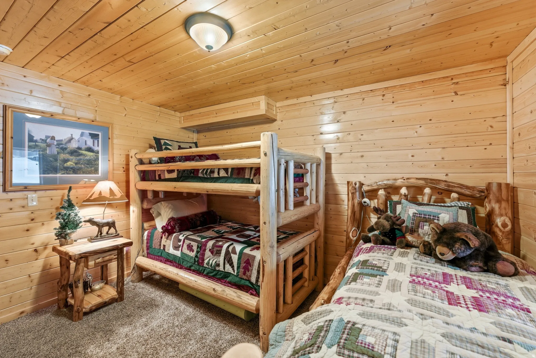 Bedroom featuring wooden walls, wood ceiling, and carpet