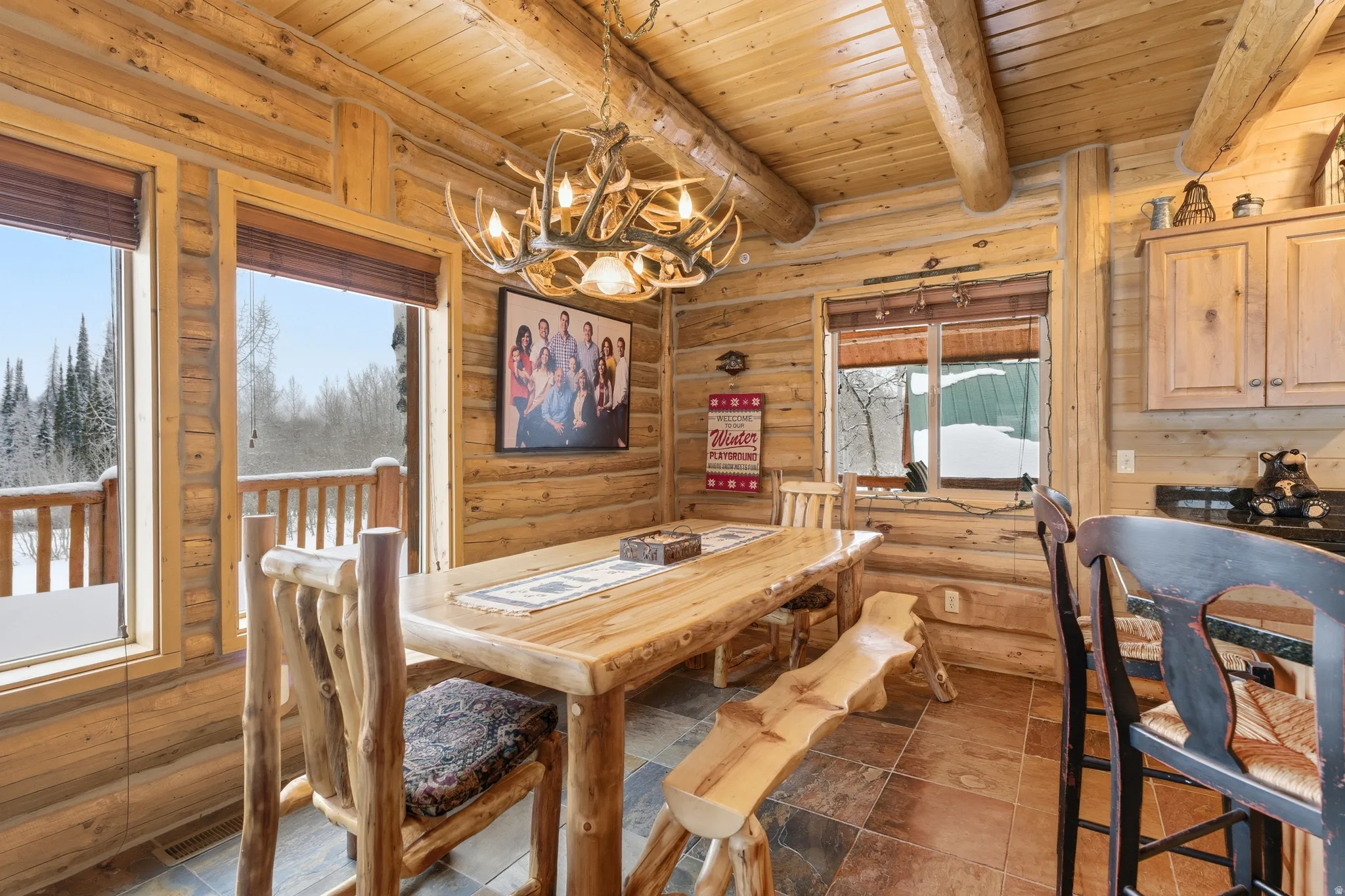 Dining area featuring hanging lights and a wooden ceiling with exposed beams