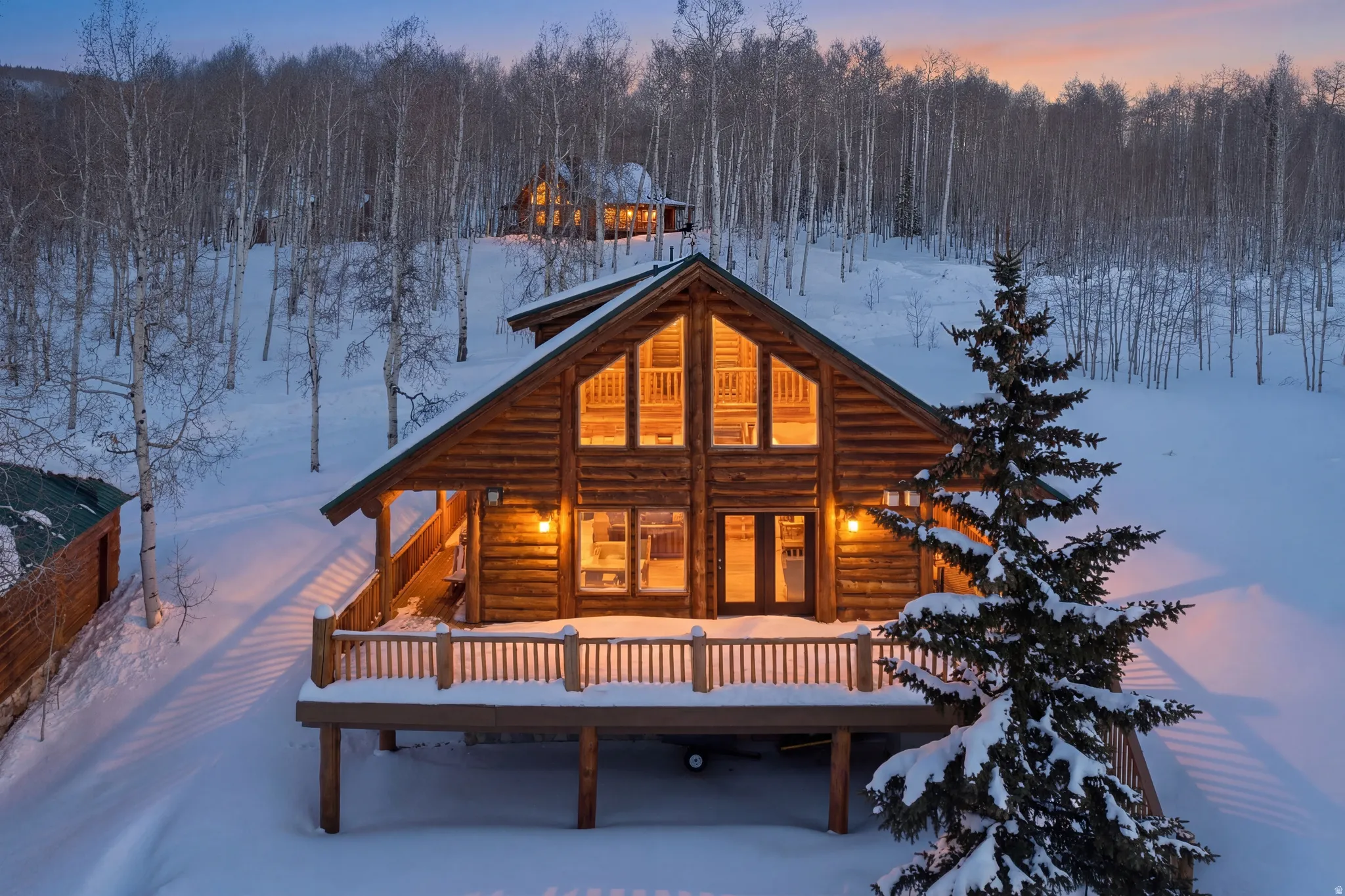 Snow covered house with a deck