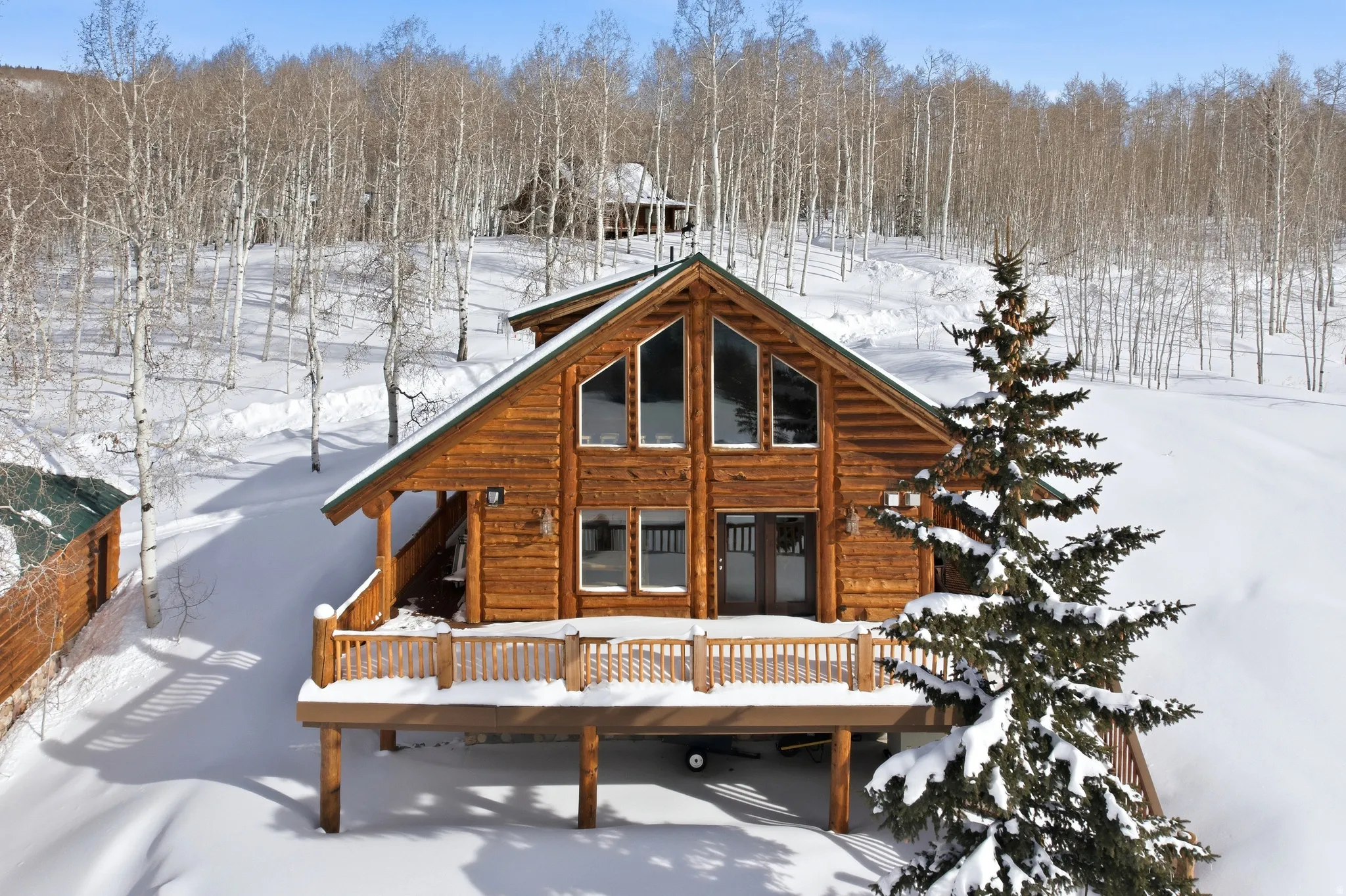Snow covered property with a deck
