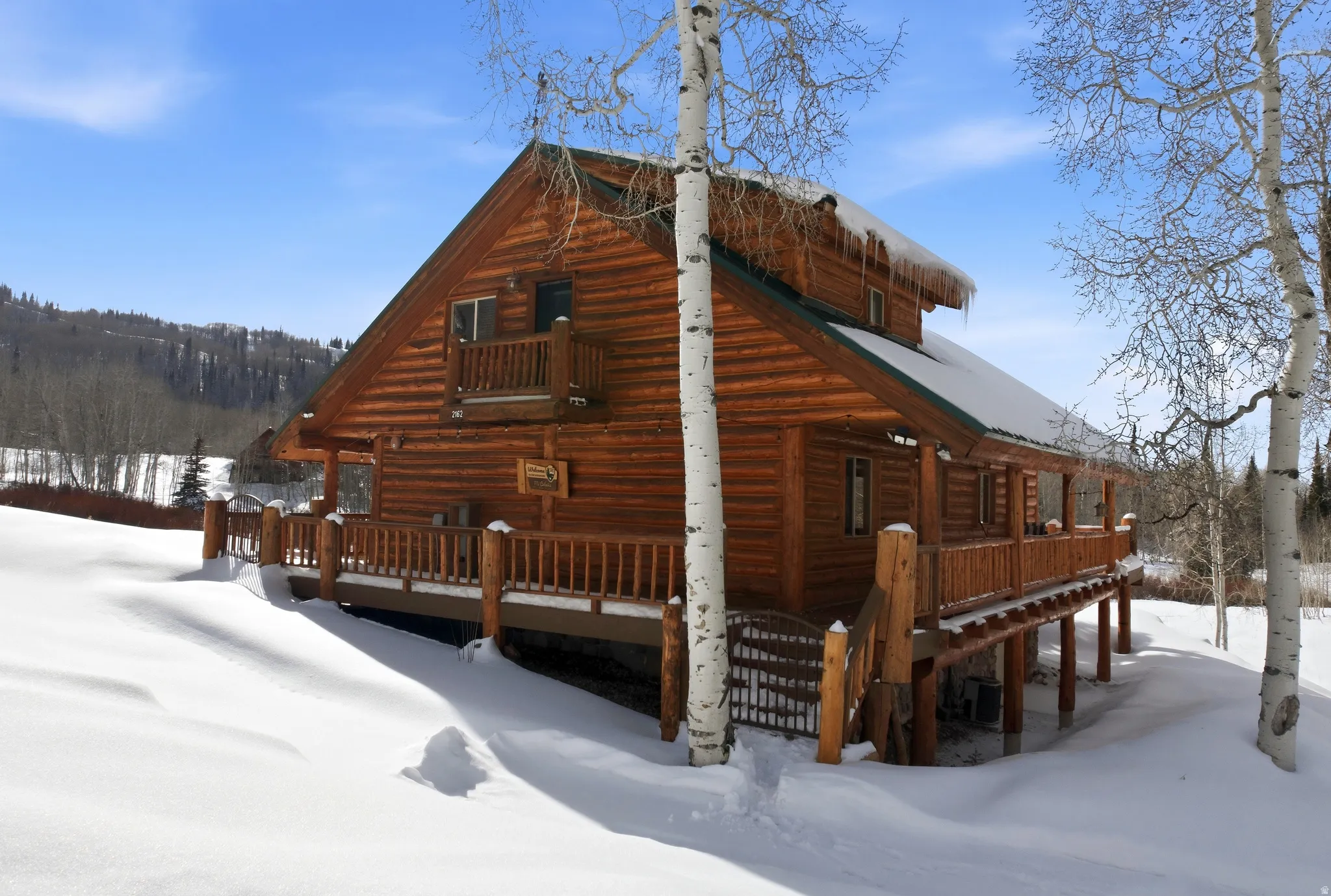 View of snowy exterior with a porch