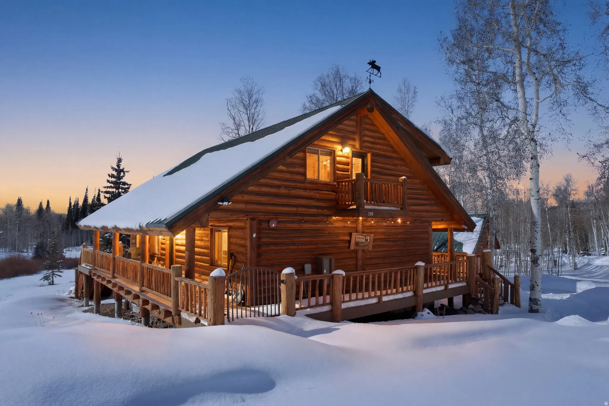 Snow covered rear of property featuring a deck