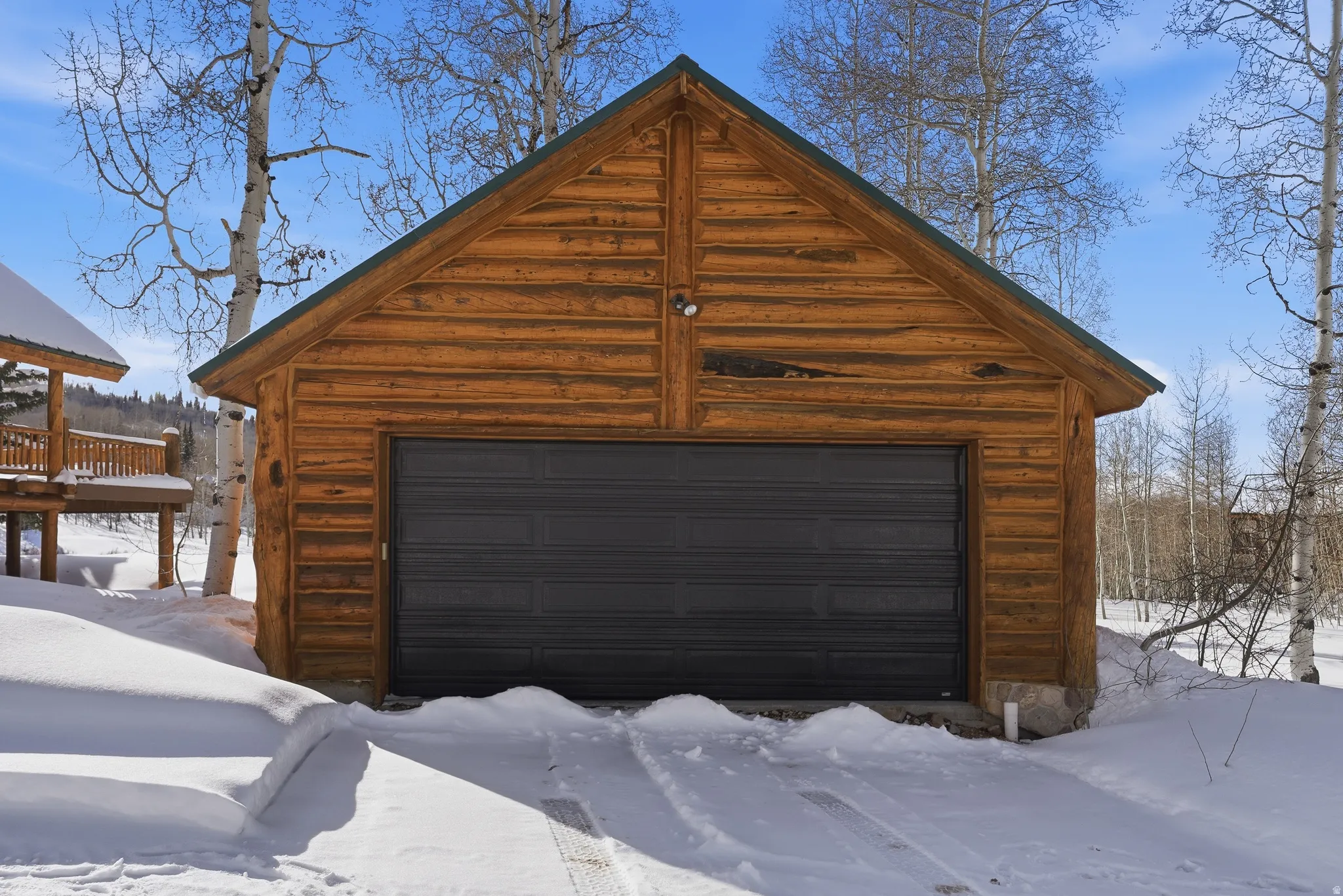 Snow covered garage with a garage