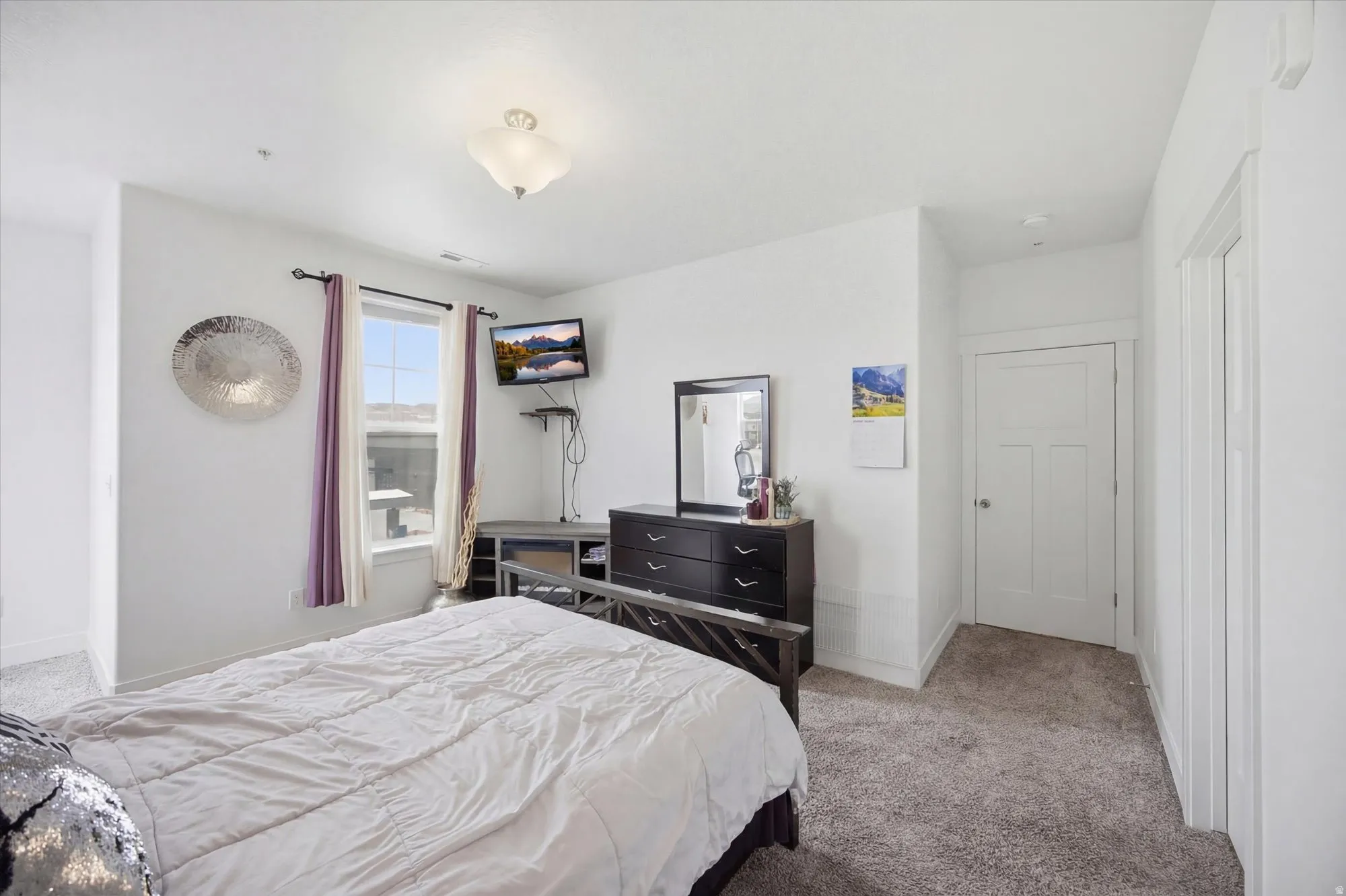 Bedroom featuring light colored carpet and baseboards