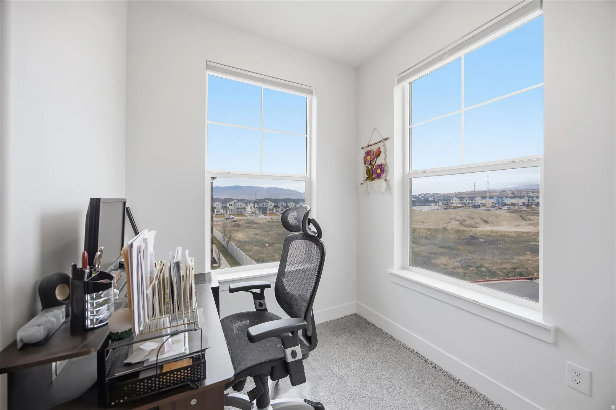 Office area featuring baseboards and light colored carpet