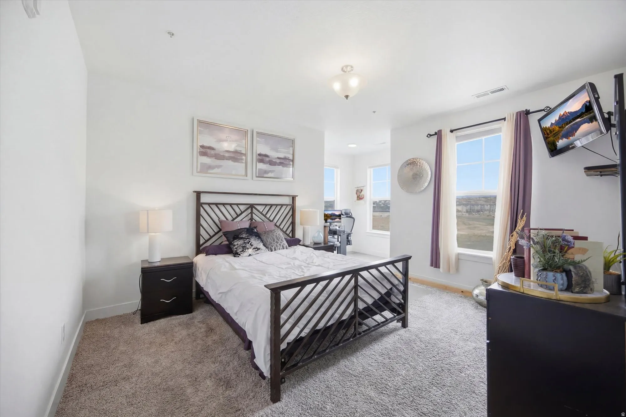 Bedroom featuring carpet and baseboards